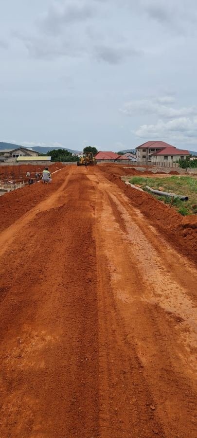 Road cutting through green hills